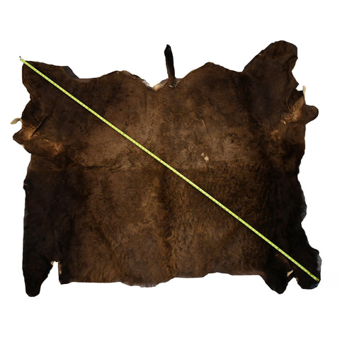 Full Brown Hair On Bison Buffalo Hide Rug Wall Hanging with diagonal tape measure showing size lying flat on white background