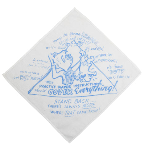 true vintage 50s or 60s white handkerchief with novelty print of a dad holding a baby by leg trying to figure out how to change a diaper with the words giving funny sayings to help him figure it out shown on white background angled like a diamond