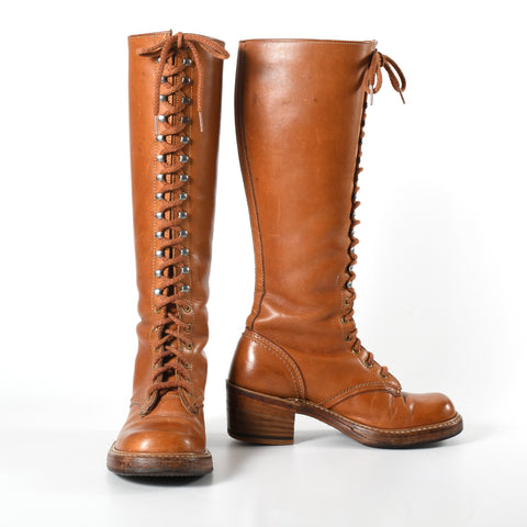 vintage 1970s brown leather lace up mid calf leather stacked heel boots with left image boot facing forward and right side image with other boot turned to show full inner side on white background