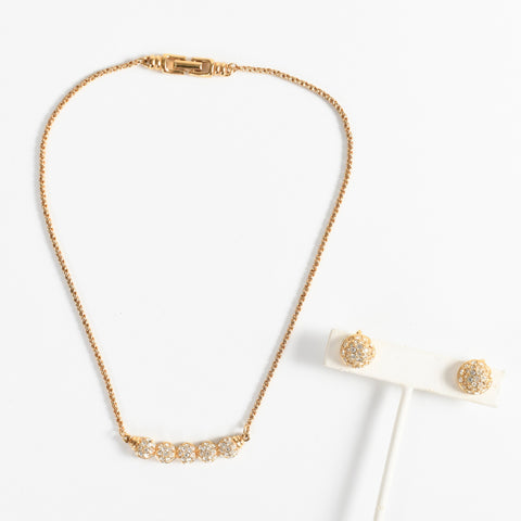 vintage 1970s gold chain Swarovski crystal gold bar necklace lying flat with 2 clip earrings on earring display lying flat both on white background