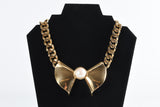 Vintage 1990s Gold Pearl Bow Pendant Bold Chain Necklace | by Nina Ricci