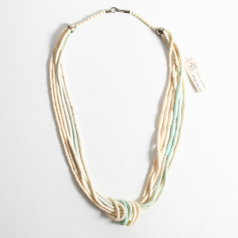 vintage 1980s bone and light aqua 6 strand 30" long necklace new old stock with tag lying flat on white background