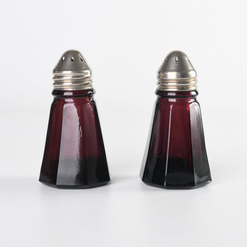 vintage 1950s purple glass octagon shaped curved pointed silver metal tip salt and pepper shakers shown next to each other on white background 