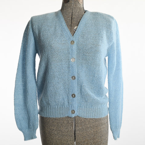 vintage 1960s soft sky blue v neck long sleeve mohair wool cardigan sweater on dress form with white backdrop