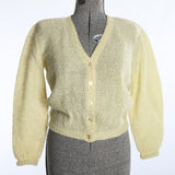 vintage 1960s pale yellow green wool mohair V neck long sleeve cardigan sweater on dress form on white backdrop