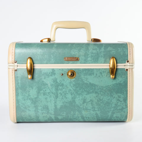 vintage 1950s bermuda green marbled hard side gold lift latches travel beauty train case shown with handle up on white background