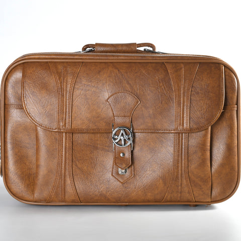 vintage 1970s American Tourister brown naugahyde suitcase with front flap pocket and silver metal logo shown on white backdrop
