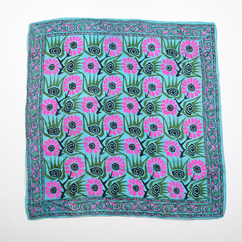 vintage 1960s bold blue background green pink black floral batik print large scarf lying flat on white backgorund