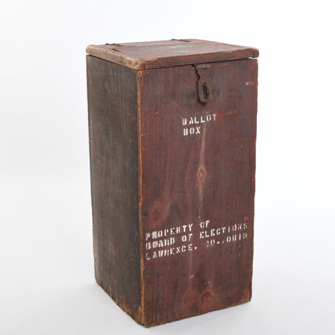 true antique red washed wood ballot box shown angled to the side with words Ballot Box in top center  white stenciling and Property of Board of Elections Lawrence, Co. Ohio stenciled in white bottom center all on white background