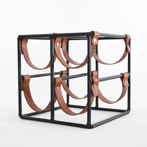 vintage 1960s black iron and brown leather strap 4 bottle wine rack cube shown angled to left sitting on white background