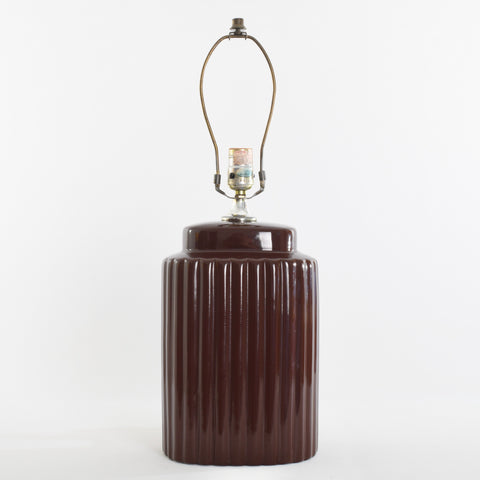 true vintage 1970s chocolate brown vertical ripples oval shaped table lamp with no shade, toggle switch and finial shown sitting on white background