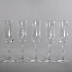 vintage 1980s set of 5 clear crystal fluted champagne glasses in navarre etched pattern  shown in line on gray background