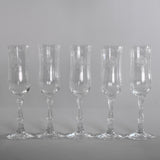 vintage 1980s set of 5 clear crystal fluted champagne glasses in navarre etched pattern  shown in line on gray background