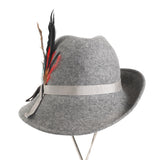 true vintage 1970s gray felted wool with red black green yellow brown side feather trim tilt womens fedora shown facing forward on thin silver metal hat stand on white background