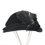 true vintage 1930s black felted wool double tiered rolled brim with silk black velvet ribbon trim and 3 large curved black feathers shown on thin silver metal 4 leg hat stand on white background