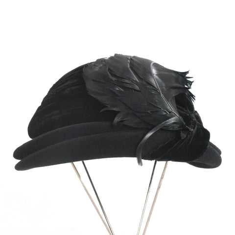 true vintage 1930s black felted wool double tiered rolled brim with silk black velvet ribbon trim and 3 large curved black feathers shown on thin silver metal 4 leg hat stand on white background