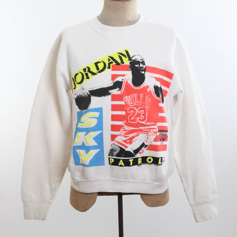 true vintage late 80s early 90s white crew neck Michael Jordan graphic sweatshirt with Michael Jordan in Bulls uniform with basketball in hand with words Jordan Sky Patrol top side and bottom shown on dress form on white background