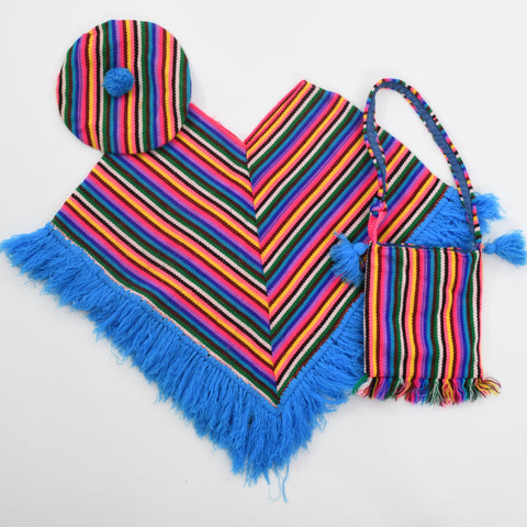 true vintage 1970s rainbow striped blue fringe bottom poncho lying flat with matching beret with pom pom in upper left corner over poncho and matching purse lower right poncho all lying on white background