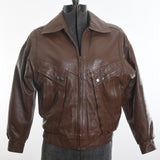 vintage 1980s brown leather bomber jacket shown on dress form against white background