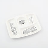 true vintage 1960s white and black vegetable print divided serving platter shown lying at an angle on white background