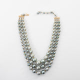 true vintage 1960s blue gray faux pearl graduated bead 3 strand necklace shown lying flat on white background