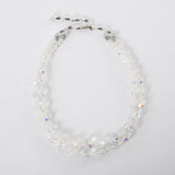 vintage 1950s clear iridescent aurora borealis two strand beaded necklace with hook closure shown lying flat in circle on white background