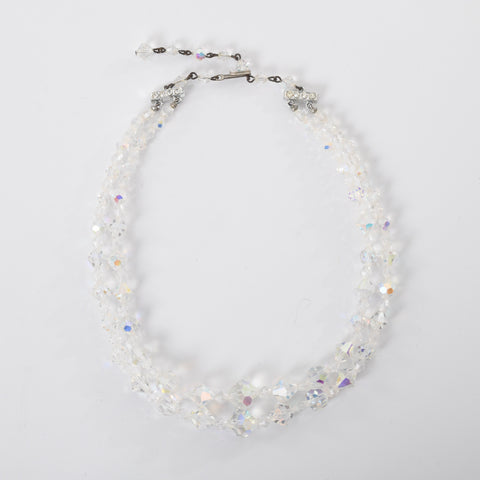 vintage 1950s clear iridescent aurora borealis two strand beaded necklace with hook closure shown lying flat in circle on white background