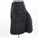 true vintage 1950s black taffeta tulip midi ruched wrap peplum skirt with gathered flat pleats on right side shown on dress form against white background