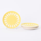 true vintage 1950s yellow white sun pattern ceramic salad plates with one standing up on clear stand at left images and 3 plates lying stacked at right all on white background