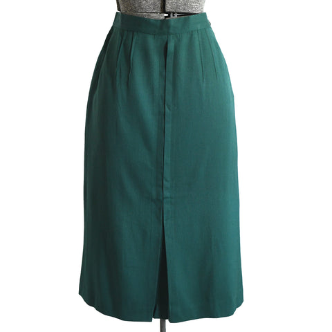 dark green 1940s gabardine midi pencil skirt with front box pleat that ends with kick pleat at center front shown on dress form against white background