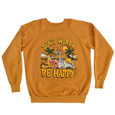 true vintage 1980s Dont Worry Be Happy lounging beach duck with ocean waves and palm trees in background all on dark mustard yellow sweatshirt lying flat on white background