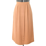 true vintage 40s warm tan gabardine midi skirt with three buttons at bottom front center pleat panel shown on dress form against white background