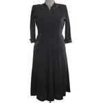 vintage 1940s black rayon crepe three quarter sleeve midi length dress with beads at neckline and side hip pocket shown on dress form against white background