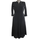 vintage 1940s black rayon crepe three quarter sleeve midi length dress with beads at neckline and side hip pocket shown on dress form against white background