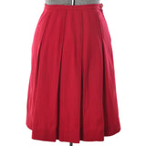 true vintage 50s cranberry red box pleated below the knee skirt shown on dress form against white background