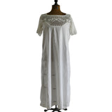 antique white chemise with upper bodice crocheted yoke featuring a bow design and flowers shown on dress form against white background