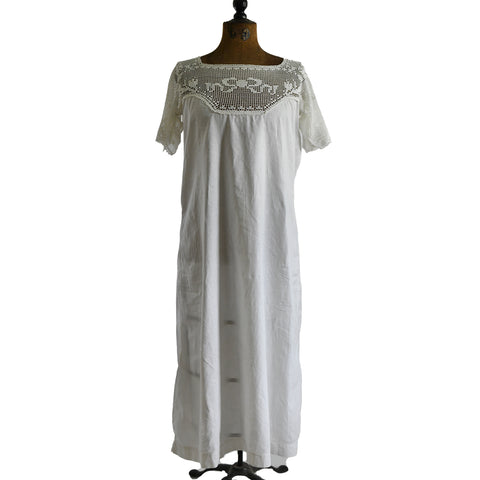antique white chemise with upper bodice crocheted yoke featuring a bow design and flowers shown on dress form against white background