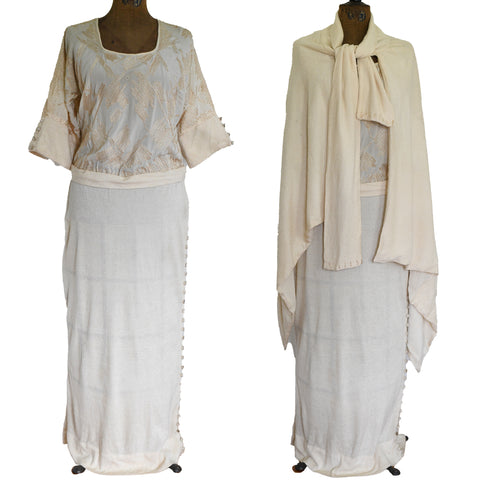cream beige dress with half sleeves and embroidered bodice with long cream skirt and buttons down right side shown on mannequin and same dress with cream beige asymmetrical cape shown on it all against white background 