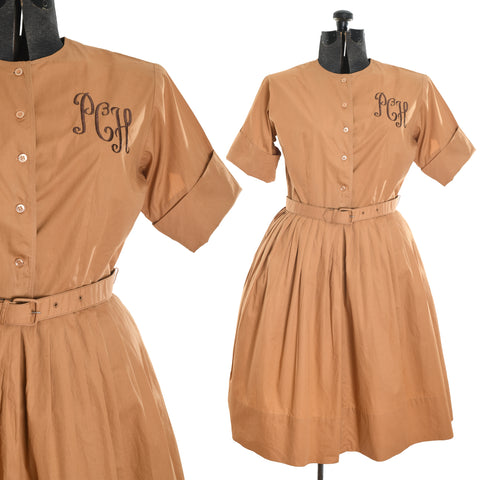 true vintage 1950s fawn brown full skirted shirt waist dress with cuffed up short sleeve, original belt and script embroidered initials PCH on upper left bodice shown on dress form right image and close up of bodice and upper skirt left image all on white background
