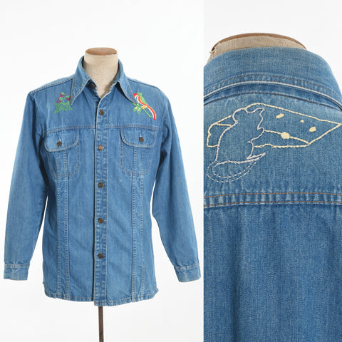 True Vintage blue denim button front overshirt jacket with flap button chest pockets and strawberries embroidered on upper left chest, tropical bird embroided right chest shown on dress form left image, back of mouse with triangle of cheese on upper back detail left image on white background