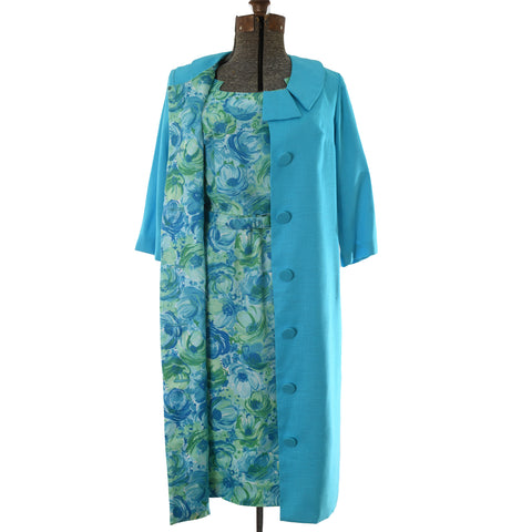 late 1950s early 1960s blue jacket and blue green floral matching pencil dress set with original belt shown on dress form against white background