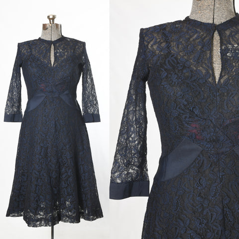 true vintage 1940s navy blue lace 3/4 sleeve mid flare skirt dress with keyhole neckline shown on dress form left image and close up of bodice right image both on white background
