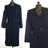 true vintage 1970s navy blue double breasted princess cut coat with matching belt shown on dress form left image and close up of bodice detail right image all on white background