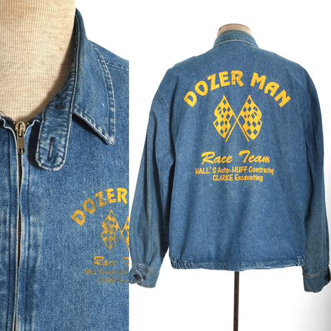vintage 1980s blue denim graphic print dozer man racing zipper tab collar jacket showing upper front detail on left image and back of jacket shown on dress form on right with white background