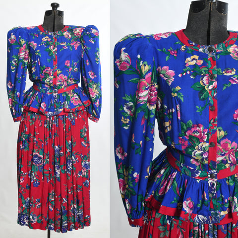 true vintage 1980s blue floral puff shoulder peplum waist top with contrasting cranberry pink gathered midi skirt suit shown fully on dress form left image and close up of bodice in right image all on white background