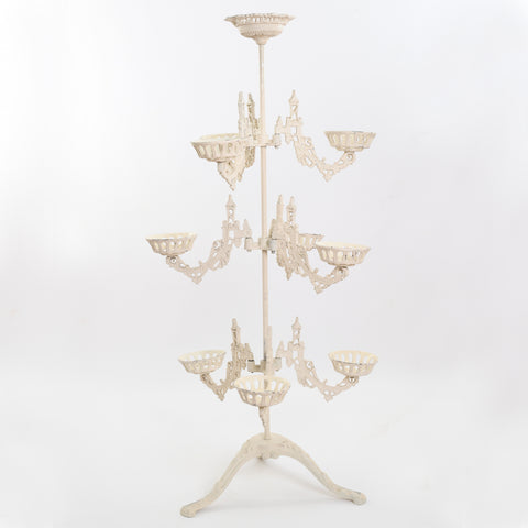 genuine antique cast metal cream plant stand with 9 moveable arms and top center holder shown on white background