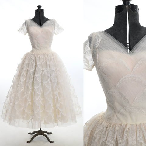vintage 1950s ivory lace blush pink tulle heart bodice short sleeve dropped waist tea length wedding dress with full dress on dress form left side and close up of bodice on right image all on white background