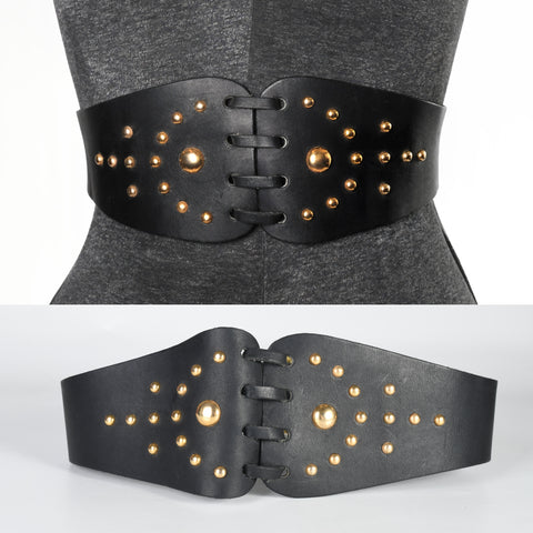 late 1950s early 1960s wide black leather gold domed metal stud cinch belt with center leather lacing shown on dress form top image and lying on white background lower image