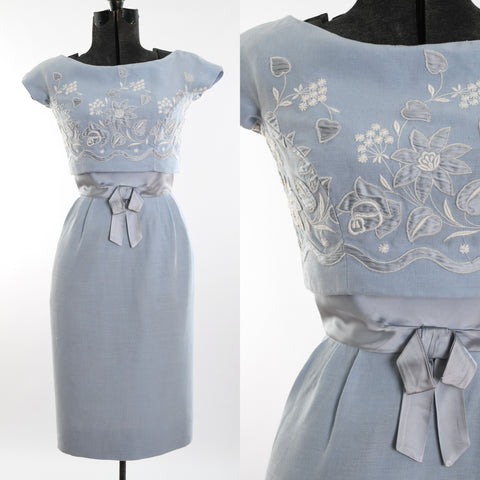 true vintage late 50s early 60s powder blue short sleeve wiggle dress with satin waistband connected to upper floral satin embroidered bodice shown on dress form left image with close up of bodice waist band detail right image all on white background