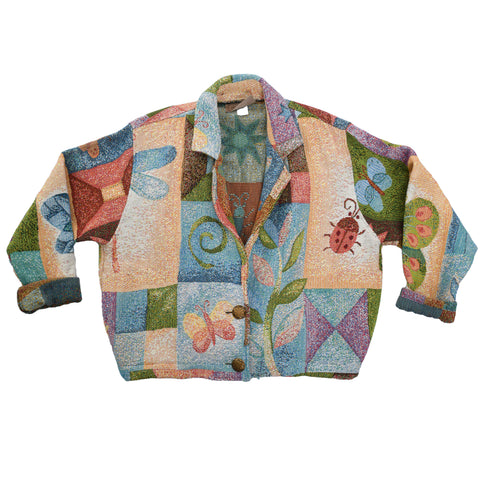 vintage 1990s bugs and flowers garden block theme tapestry jacket with two front buttons shown lying flat on white background